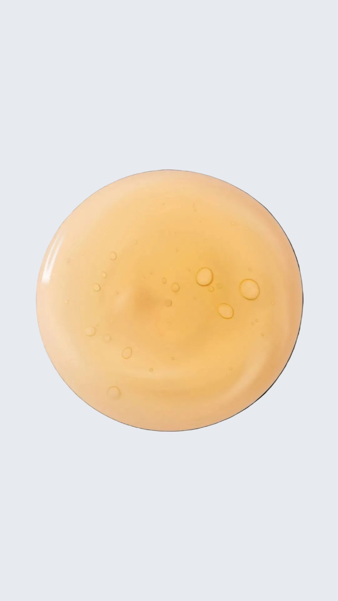 Amber-colored gel or cream on a white background