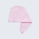 Pink towel with a brand label on a light gray background