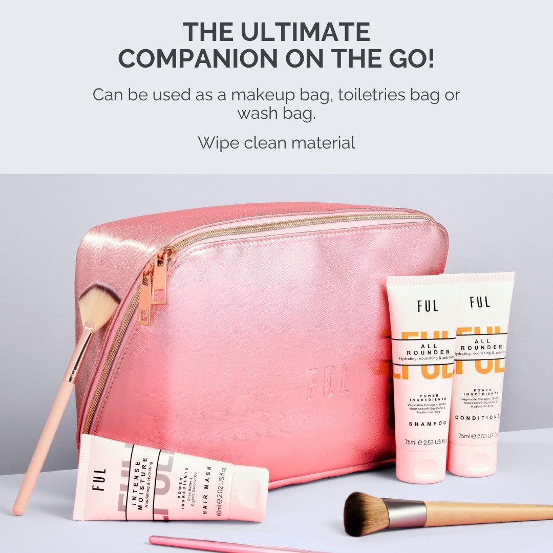 Pink toiletry bag with cosmetic products and brushes on a light gray background