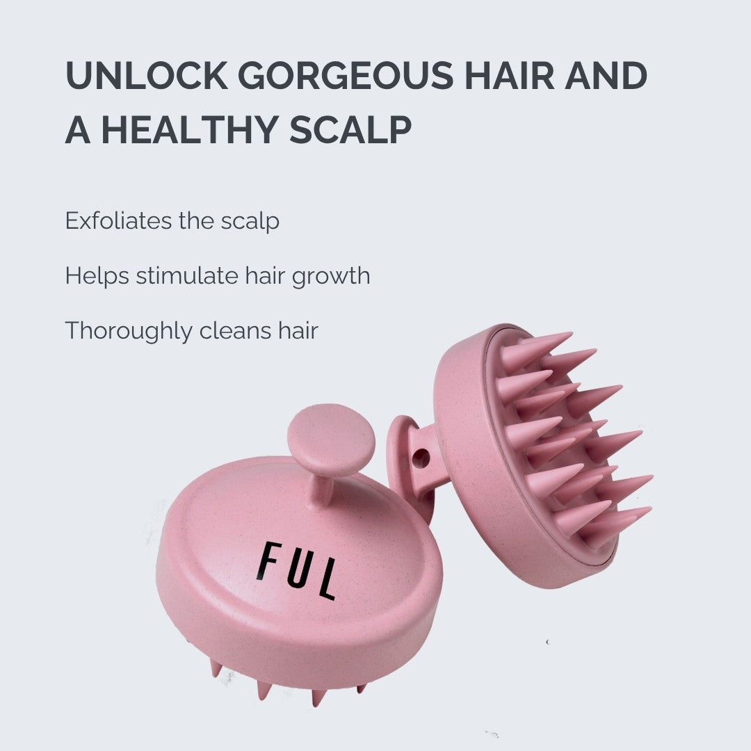 Pink scalp massage tool with text on a light gray background