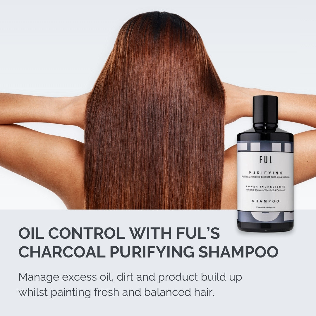 Person with long hair holding a bottle of Ful Charcoal Purifying Shampoo on a light gray background